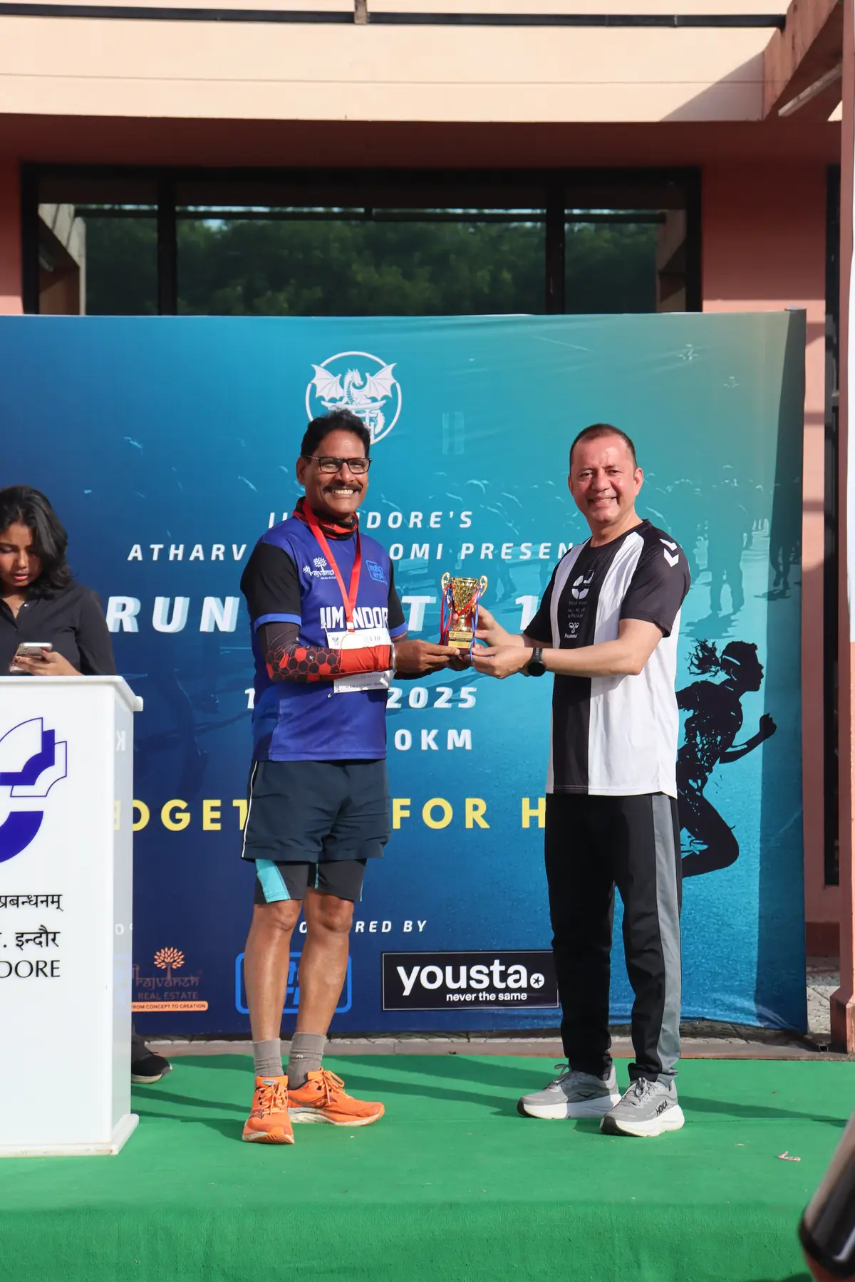 A trophy changing hands at the prize ceremony